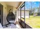 Enclosed porch featuring a chair swing, and chairs at 1920 Commander Way, Kissimmee, FL 34746