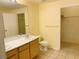 Bathroom features a double sink vanity, tile flooring, and a separate room for the closet at 1980 Erving Cir # 107, Ocoee, FL 34761