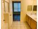 Large bathroom featuring double sinks, tile flooring, and a separate shower and bedroom at 1980 Erving Cir # 107, Ocoee, FL 34761