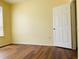 Bedroom with wood floors and a door ajar at 1980 Erving Cir # 107, Ocoee, FL 34761