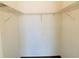 Walk-in closet featuring wire shelving and wood flooring providing ample storage space at 1980 Erving Cir # 107, Ocoee, FL 34761