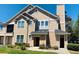 Inviting townhouse with beige siding, chimney, well-kept lawn and two front doors at 1980 Erving Cir # 107, Ocoee, FL 34761