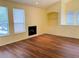 Bright living room featuring wood floors, a fireplace, built in shelving, and windows for natural light at 1980 Erving Cir # 107, Ocoee, FL 34761