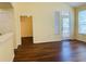 Living room with wood floors, fireplace, windows, and doorway to another room at 1980 Erving Cir # 107, Ocoee, FL 34761