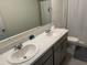 Bright bathroom featuring double sinks, a large mirror, and a shower with curtain at 2232 Tay Wes Dr, St Cloud, FL 34771