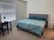 Bedroom featuring a cozy bed, a desk with a modern lamp, and a nightstand by the window at 2232 Tay Wes Dr, St Cloud, FL 34771