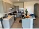 Modern kitchen featuring gray cabinets, stainless steel appliances, and a functional center island at 2232 Tay Wes Dr, St Cloud, FL 34771