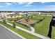 A community playground with modern equipment is surrounded by a fence and well-maintained green space at 2232 Tay Wes Dr, St Cloud, FL 34771
