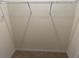Bright walk-in closet featuring upper shelving and neutral carpeting for ample storage at 2232 Tay Wes Dr, St Cloud, FL 34771