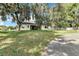 Spacious backyard featuring mature trees and a screened-in lanai, perfect for outdoor relaxation at 2425 Rambling Oaks Way, Kissimmee, FL 34746