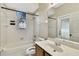 Bathroom with shower-tub combo, mirror and vanity with sink and faucet at 2425 Rambling Oaks Way, Kissimmee, FL 34746