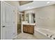 Clean bathroom featuring a glass shower, soaking tub, and tile flooring at 2425 Rambling Oaks Way, Kissimmee, FL 34746
