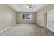 Bright bedroom with a ceiling fan, plush carpeting, and a large window with water views at 2425 Rambling Oaks Way, Kissimmee, FL 34746