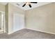Bright bedroom with neutral walls, carpet, and a double-door closet at 2425 Rambling Oaks Way, Kissimmee, FL 34746