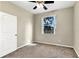 Carpeted bedroom with a ceiling fan and a water view from the large window at 2425 Rambling Oaks Way, Kissimmee, FL 34746