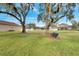 Beautiful community park with mature trees and benches for relaxing by the backyard pools of the homes at 2425 Rambling Oaks Way, Kissimmee, FL 34746