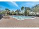 Beautiful community pool with lounge chairs, palm trees, and a serene environment for residents at 2425 Rambling Oaks Way, Kissimmee, FL 34746