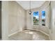 Cozy dining area featuring large windows with views of the water and an elegant hanging light at 2425 Rambling Oaks Way, Kissimmee, FL 34746