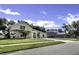 Attractive home with a manicured lawn, mature trees, and a paved driveway at 2425 Rambling Oaks Way, Kissimmee, FL 34746