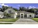 Inviting exterior showcasing arched windows, lush landscaping, and a brick driveway at 2425 Rambling Oaks Way, Kissimmee, FL 34746