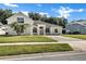 Charming two-story home featuring a well-manicured lawn and a paved driveway at 2425 Rambling Oaks Way, Kissimmee, FL 34746