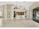 Open-concept living space with tile floors, kitchen access, and sliding doors at 2425 Rambling Oaks Way, Kissimmee, FL 34746