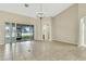 Bright living room with tile floors, high ceilings, and sliding glass doors to the outdoor area at 2425 Rambling Oaks Way, Kissimmee, FL 34746