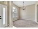 Neutral living space features a statement chandelier and lots of natural light at 2425 Rambling Oaks Way, Kissimmee, FL 34746