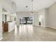 Spacious living area with tile floors, a sliding glass door, and kitchen views at 2425 Rambling Oaks Way, Kissimmee, FL 34746