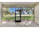 Screened in porch with a beautiful view of the lake and surrounding trees at 2425 Rambling Oaks Way, Kissimmee, FL 34746