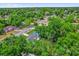 Aerial view of the property nestled among mature trees in a quiet neighborhood at 247 S Marydell Ave, Deland, FL 32720