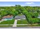 A high angle shot of the front of the house and it's neighborhood location with ample tree coverage at 247 S Marydell Ave, Deland, FL 32720