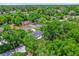 Overhead angle showing the property with lush tree coverage, a quiet neighborhood and other houses nearby at 247 S Marydell Ave, Deland, FL 32720