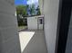 View of the side yard with an exterior building featuring white walls and a concrete slab at 247 S Marydell Ave, Deland, FL 32720