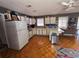 A spacious kitchen with white cabinets, updated appliances, and a functional layout with an island at 247 S Marydell Ave, Deland, FL 32720