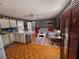 Open-concept living room featuring a kitchen and a seating area with couch and a large armoire at 247 S Marydell Ave, Deland, FL 32720