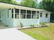 Charming home featuring a screened-in sunroom and a freshly painted exterior at 247 S Marydell Ave, Deland, FL 32720