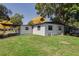 The home has a bright green backyard with access to a carport for covered parking and outdoor activities at 2827 Sanka Dr, Orlando, FL 32826