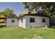 The backyard is green and lush, offering space for outdoor activities, with access to a carport at 2827 Sanka Dr, Orlando, FL 32826