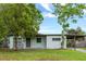 Charming single-story home with a well-maintained lawn and mature trees providing ample shade at 2827 Sanka Dr, Orlando, FL 32826