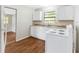 Cozy kitchen with white cabinets, laminate countertops, and a white electric range oven at 2827 Sanka Dr, Orlando, FL 32826