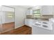 Cozy kitchen with white cabinets, laminate countertops, and a white electric range oven at 2827 Sanka Dr, Orlando, FL 32826