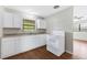 Clean and tidy kitchen featuring white cabinets, laminate countertops and a white electric range oven at 2827 Sanka Dr, Orlando, FL 32826