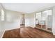 Bright living room featuring wood floors and entrance to an additional room with a utility closet at 2827 Sanka Dr, Orlando, FL 32826