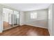 Bright living room featuring wood floors and entrance to kitchen with white refrigerator at 2827 Sanka Dr, Orlando, FL 32826