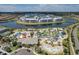 Aerial view of the waterpark lazy river, slides, lush landscaping, and community buildings around a scenic lake at 3120 Paradox Cir # 101, Kissimmee, FL 34746