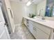 Modern bathroom featuring a double sink vanity, light countertops, and neutral tile flooring, exuding sophistication at 3120 Paradox Cir # 101, Kissimmee, FL 34746