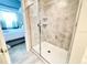 Clean bathroom featuring a walk-in shower with glass doors and bedroom view at 3120 Paradox Cir # 101, Kissimmee, FL 34746