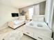 Comfortable bedroom featuring two beds with drawer storage, a flat-screen TV, and stylish wall decor at 3120 Paradox Cir # 101, Kissimmee, FL 34746