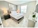 Bright bedroom featuring a queen bed, stylish gray walls, and matching bedside table, creating a relaxing retreat at 3120 Paradox Cir # 101, Kissimmee, FL 34746